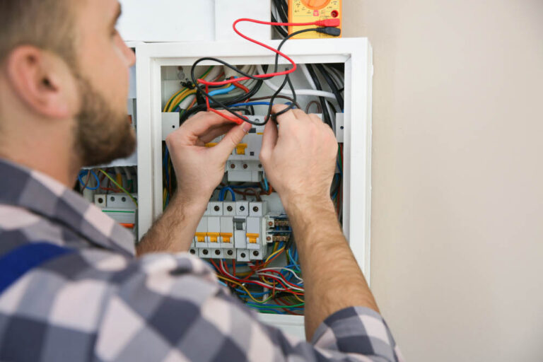 Technician tinkering with an electrical panel